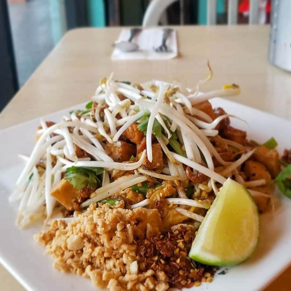 Wat Dong Moon Lek Noodle's Pad Thai with tofu, bean sprouts, crushed peanuts, and a lime wedge.