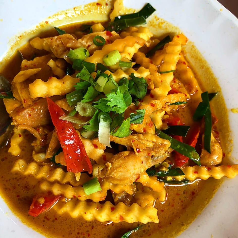 Wat Dong Moon Lek Noodle's Thai curry with wavy-cut potatoes, chicken, red peppers, and herbs.